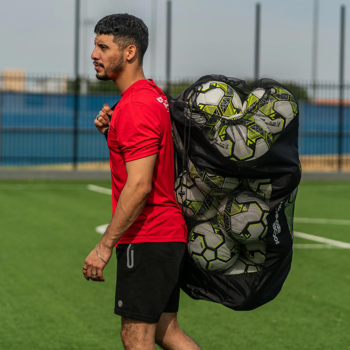Coach Carrying a Heavy Duty Soccer Ball Bag