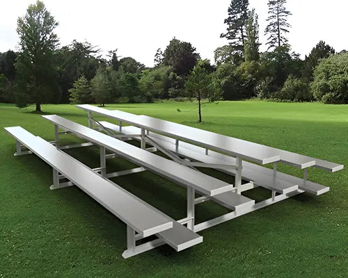 Hero image: three-row aluminum stadium bleachers at an outdoor athletic field