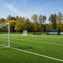 September multi-sport school field with soccer goal, lacrosse goal, team shelter, and bleachers