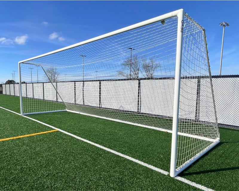 Aluminum soccer goal on grass field with net installed, ideal for schools, colleges, and youth clubs from Goals4Sports®