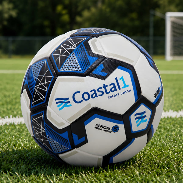 Customized Coastal1 Credit Union soccer ball displayed on a grass field with a soccer goal in the background.