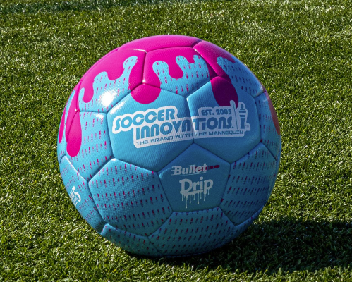 Drip Soccer Ball in blue and pink with paint-drip graphic resting on green artificial turf