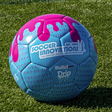 Drip Soccer Ball in blue and pink with paint-drip graphic resting on green artificial turf