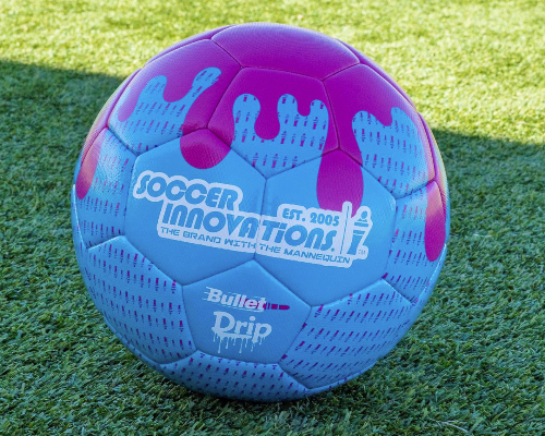 Close-up of the blue and pink Drip Soccer Ball showing textured surface and bold drip design on artificial turf