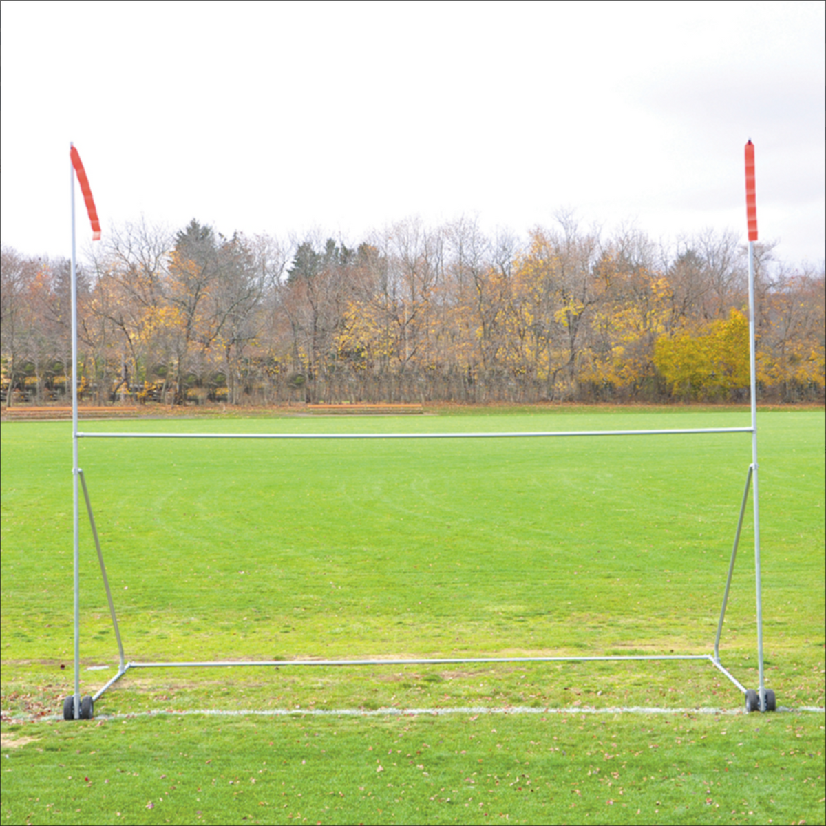 Jaypro portable high school football practice goal with H-frame, wheels, and red wind streamers on a grass field.