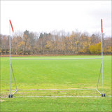 Jaypro portable high school football practice goal with H-frame, wheels, and red wind streamers on a grass field.