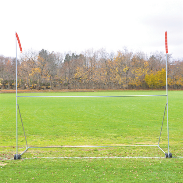 Jaypro portable high school football practice goal with H-frame, wheels, and red wind streamers on a grass field.