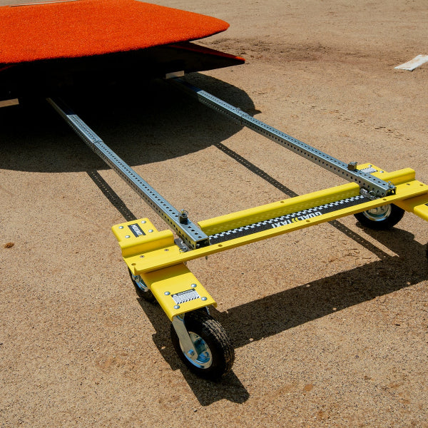 Mound Taxi positioned under a portable pitching mound on a baseball infield