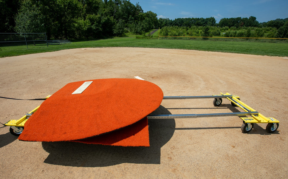 Portable pitching mound loaded onto Mound Taxi transport system on baseball field