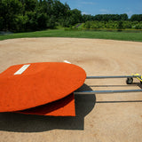 Portable pitching mound loaded onto Mound Taxi transport system on baseball field