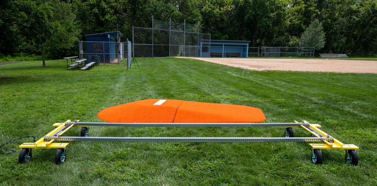 Mound Taxi transport frame positioned in front of baseball field and dugouts