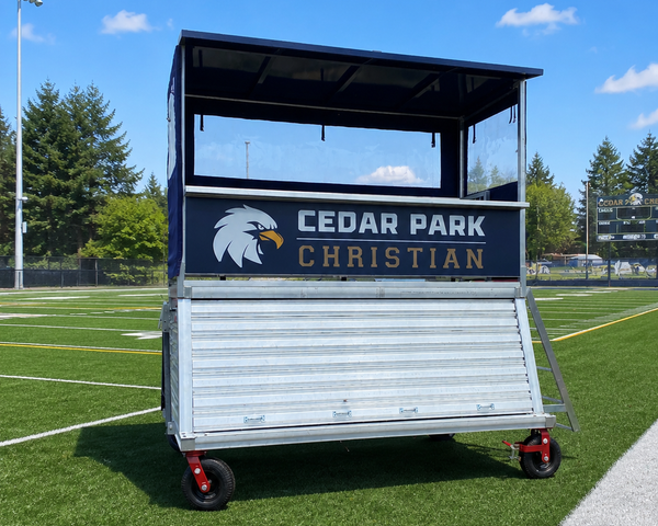 Portable elevated sports press box with aluminum platform, access ladder, and canopy