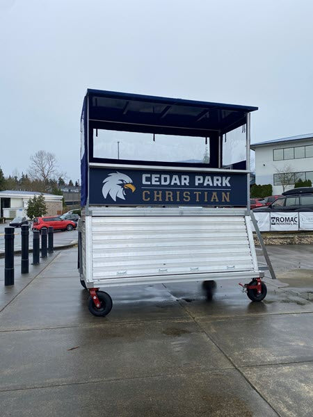 Portable press box and filming tower with open front for athletic event operations