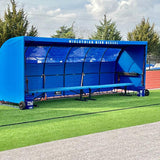 Custom MVP team shelter replacement cover in royal blue with bench on outdoor athletic field sideline