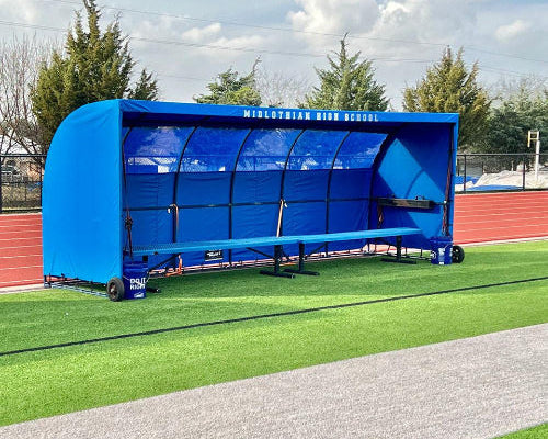 Custom MVP team shelter replacement cover in royal blue with bench on outdoor athletic field sideline