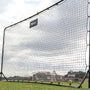 Large black sports net on a grassy field with a cloudy sky.