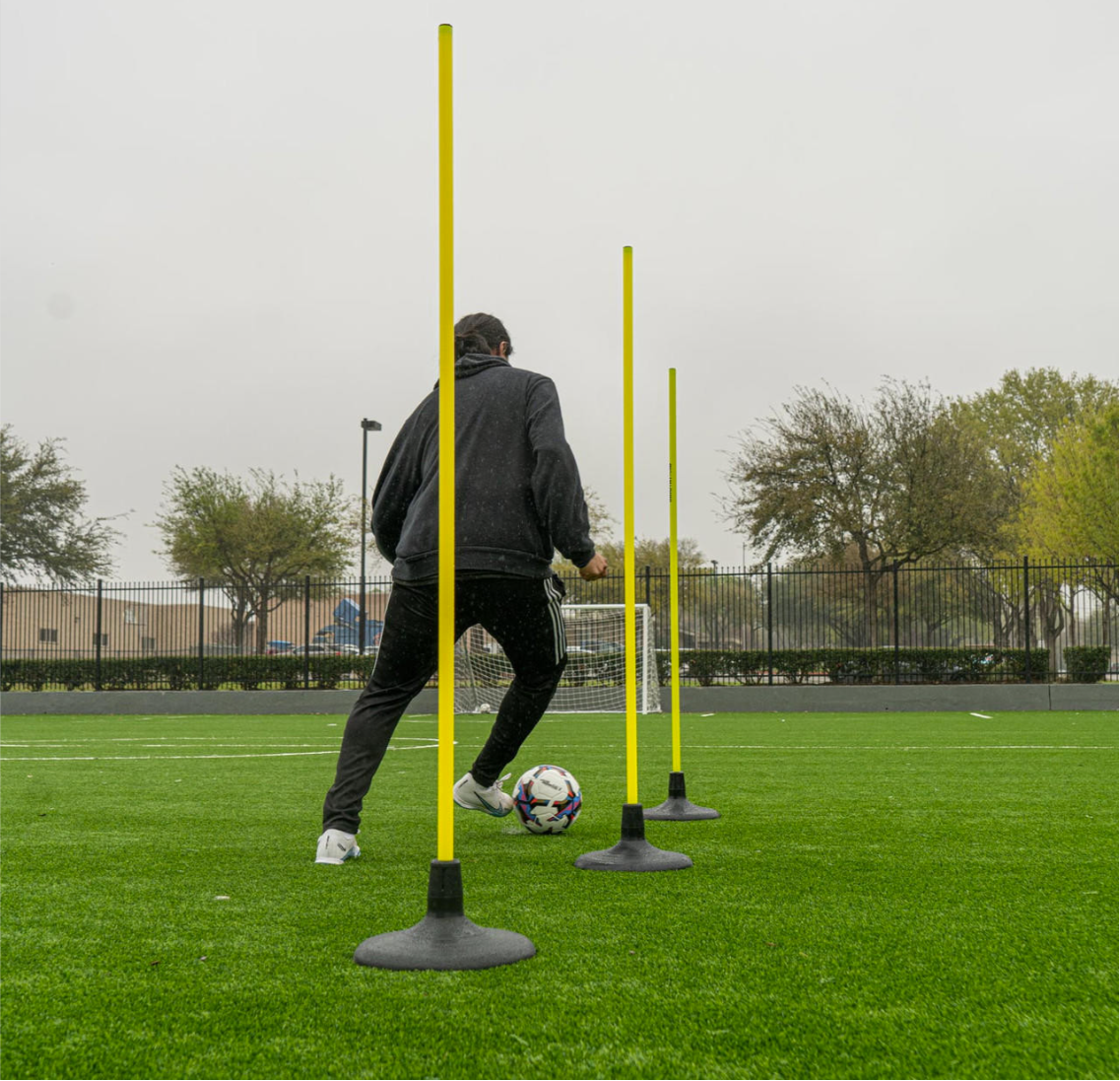 Soccer speed pole secured in jumbo turf base on artificial turf