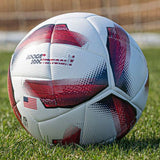 Spark Soccer Ball 2026 USA edition size 5 in red white and blue on grass field near soccer goal net