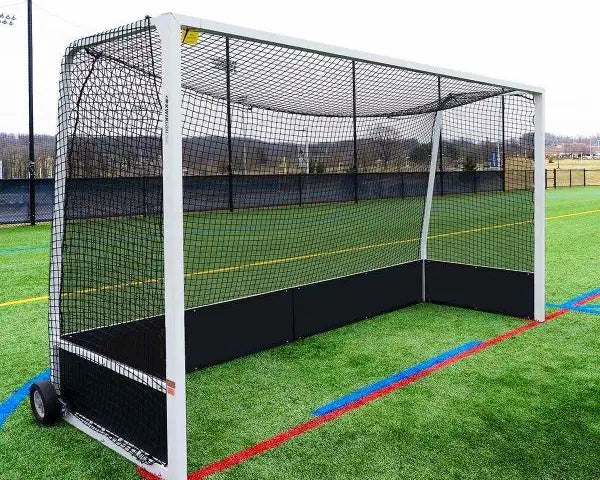Portable field hockey goal with white frame, black netting, and black backboards on a synthetic turf field.