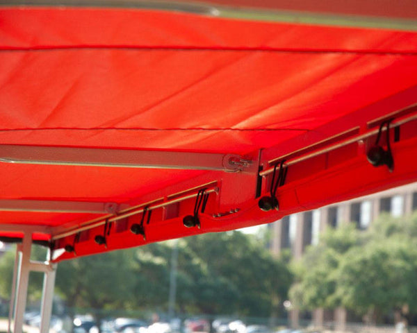 MVP team shelter replacement cover interior showing bungee attachment system and red weather-resistant canopy fabric