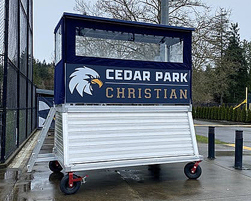 Portable Sports Press Box – Color and Option Choices Portable press box with aluminum frame, powder coated roof, and color options displayed on a field