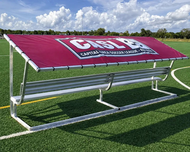 Rear angled view of a 15ft aluminum covered bench with a burgundy tarp and white CASL soccer league logo.